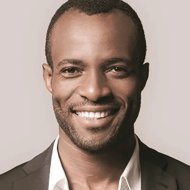 Smiling man in a dark jacket, an editorial portrait from Modern Touch Dental's previous website.