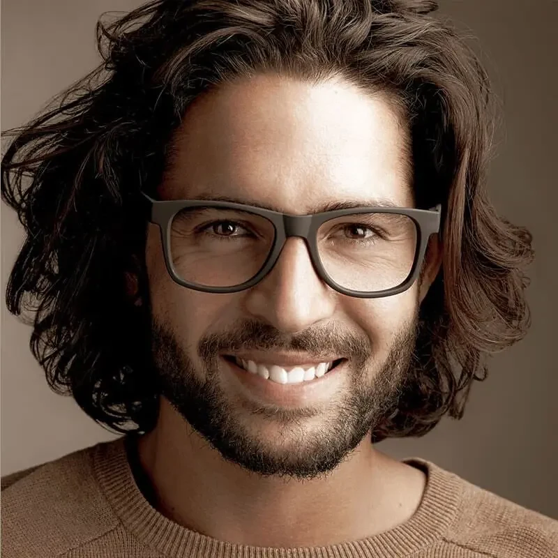 Smiling man wearing glasses, an editorial portrait from Modern Touch Dental's previous website.