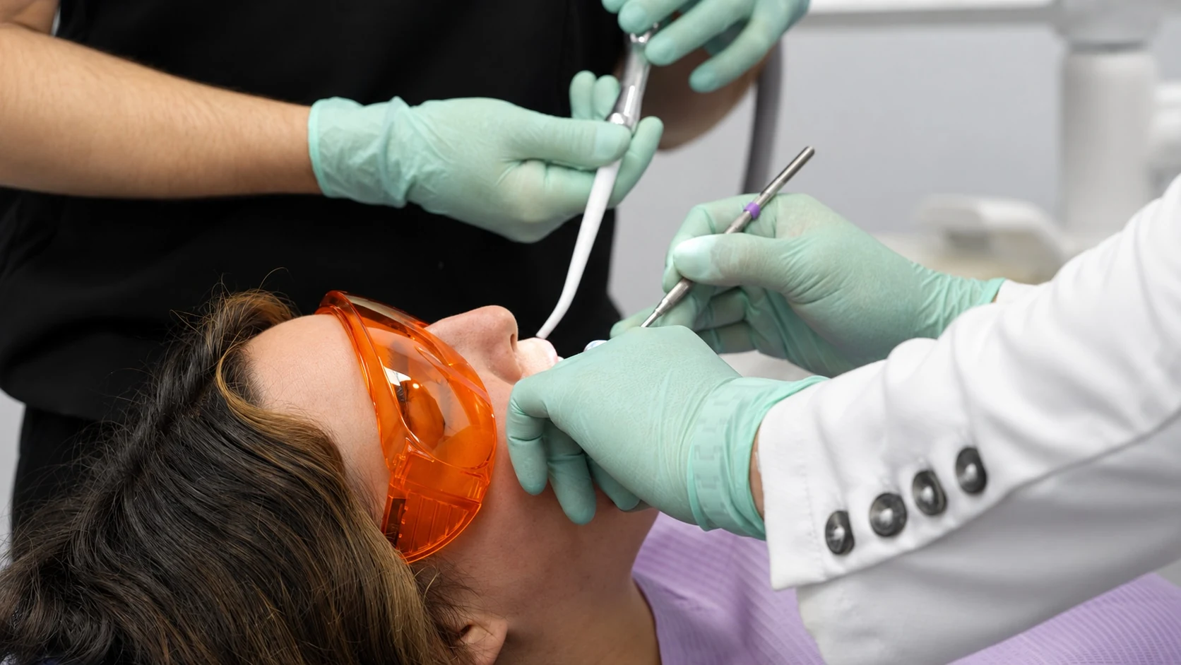 The Modern Touch Dental team providing care to a patient wearing protective glasses