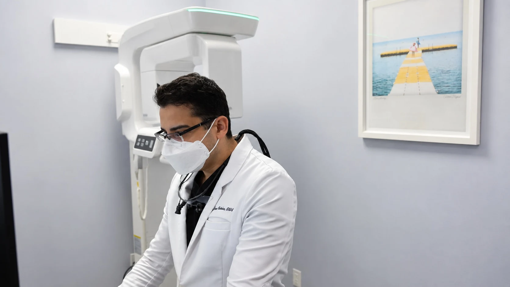 A Modern Touch Dental clinician working beside the office imaging equipment